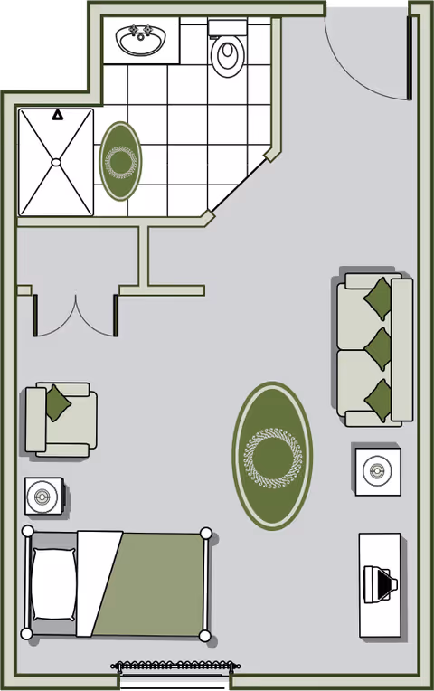 Floor plan of a senior living facility room showing a bedroom area with a bed, armchair, and side table, a living area with a sofa, coffee table, and TV stand, and a bathroom with a shower, sink, and toilet.