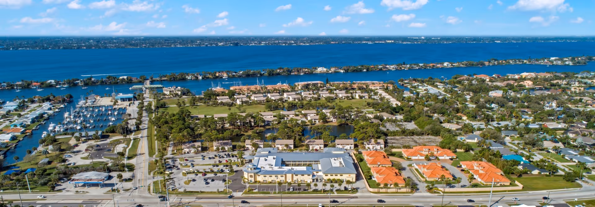 Aerial view of the Zon Beachside campus and nearby marina along the coastline with surrounding residential neighborhood.