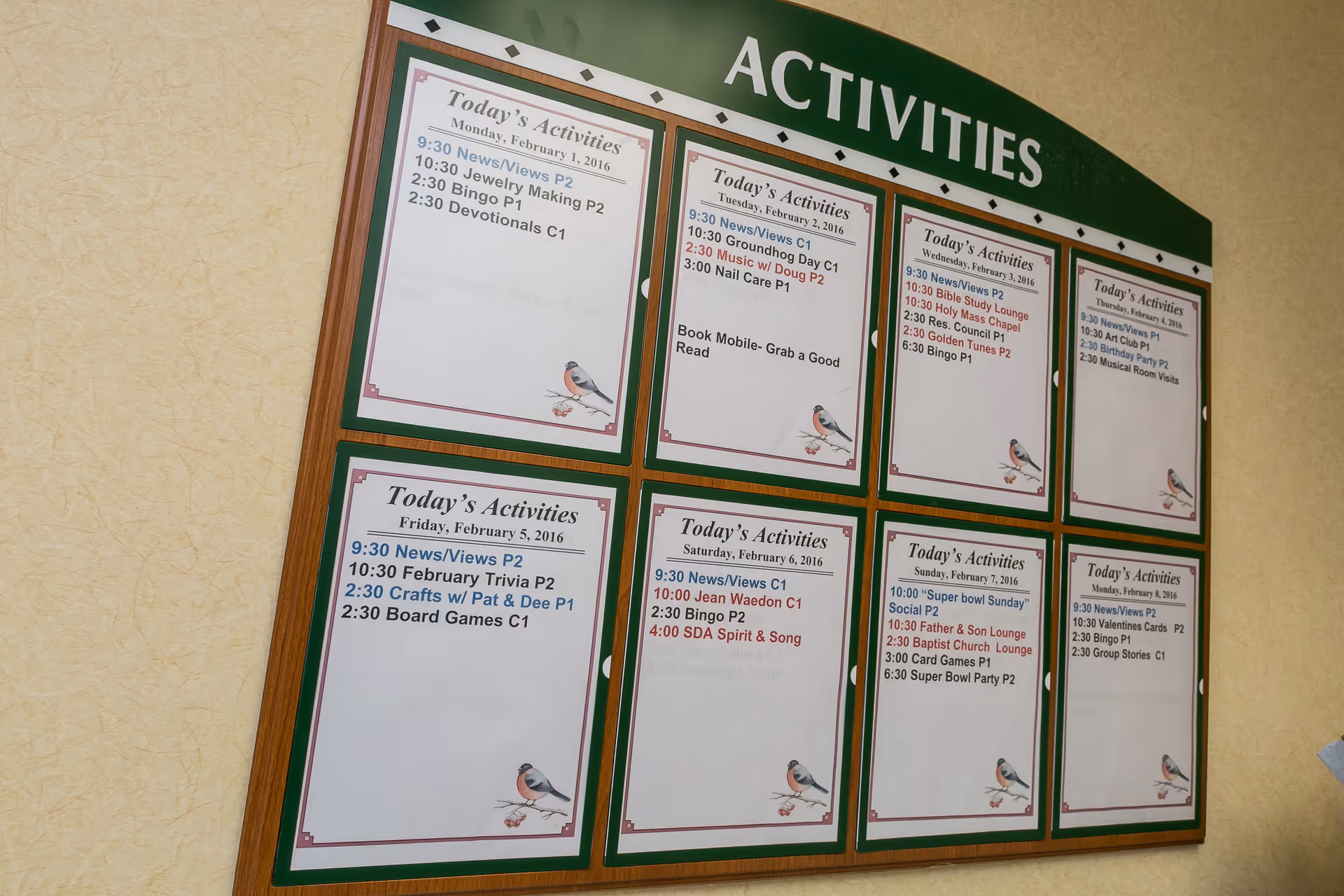 A wall-mounted bulletin board titled 'ACTIVITIES' displaying printed daily activity schedules.