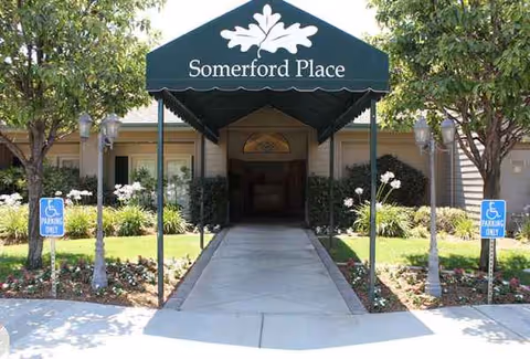 Entrance to Summerfield Place senior living with a covered walkway and handicapped parking.