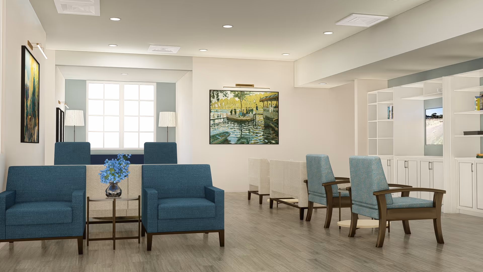 Bright communal sitting area with blue upholstered chairs, small tables, artwork on the walls and built-in shelving.