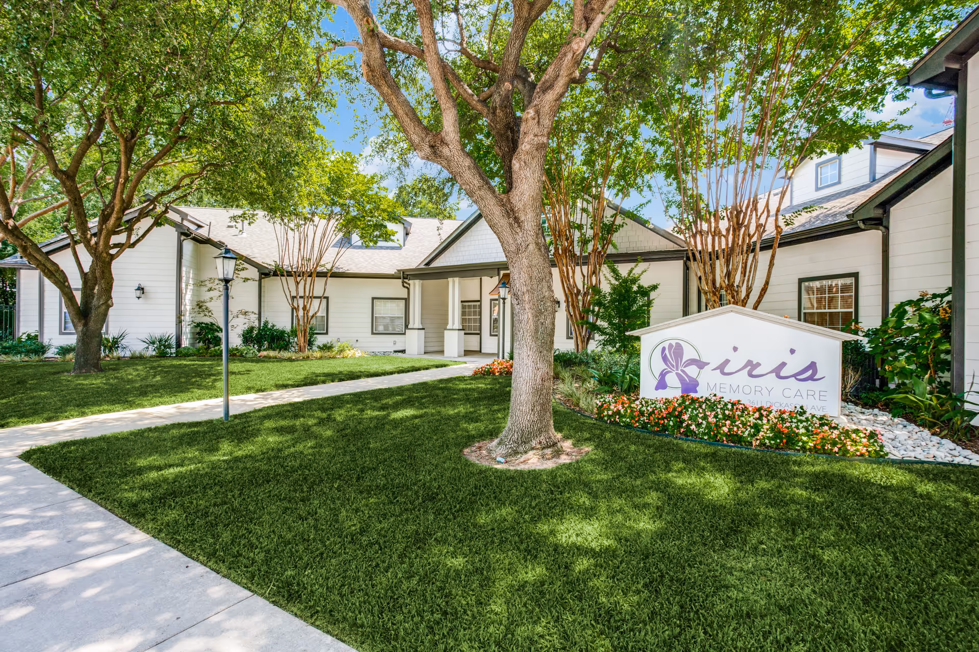 Exterior view of Silverado Turtle Creek with landscaped garden, pathway, and sign.