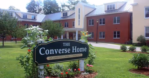Exterior view of Converse Home building with a green lawn and a prominent sign.