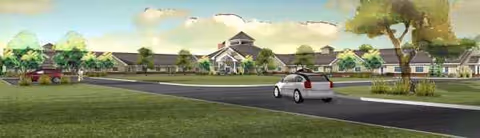Exterior view of Bluebird Retirement Community with road, car, and low-rise buildings.