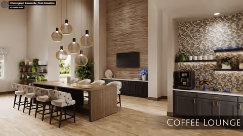 A modern coffee lounge with a long wooden table surrounded by cushioned chairs. Pendant lights hang above the table. The room features a textured accent wall with a mounted flat-screen TV, and a coffee station with a coffee machine, cups, and decorative plants on shelves. The space has large windows allowing natural light to brighten the room.