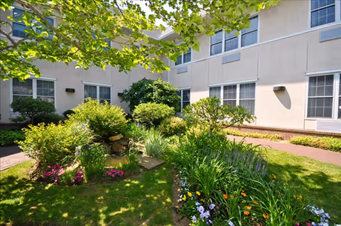 Exterior view of Huntington Hills Center for Health and Rehabilitation with a landscaped courtyard