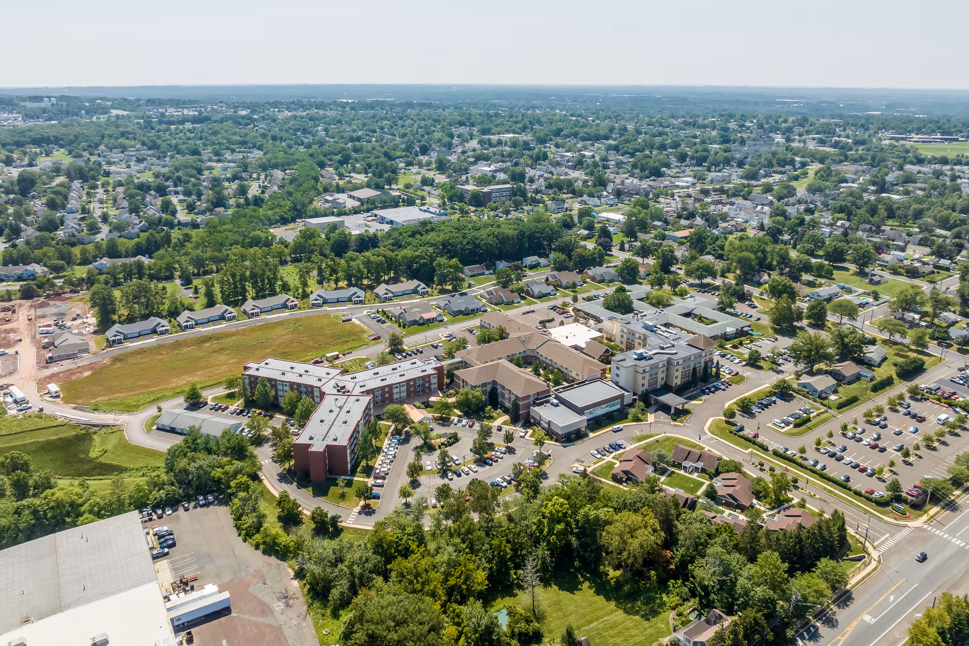 Aerial view of the Lutheran Community at Telford campus with multiple connected buildings, parking lots, and surrounding homes and greenery.