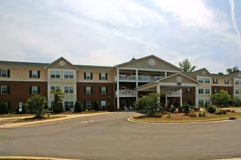 Exterior view of Weatherstone Spring senior living facility with a covered entrance.