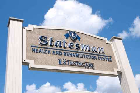 Exterior view of the Statesman Health and Rehabilitation Center sign against a blue sky.