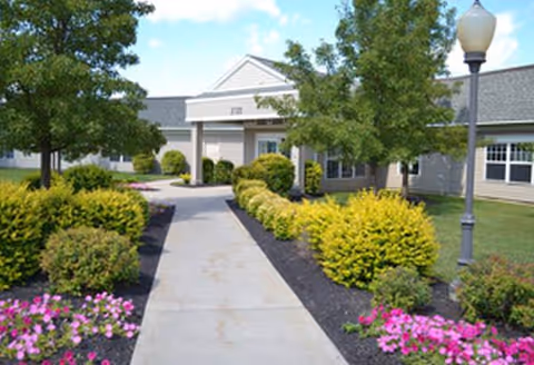 Front of Weinberg Garden House with a paved walkway and landscaped garden.