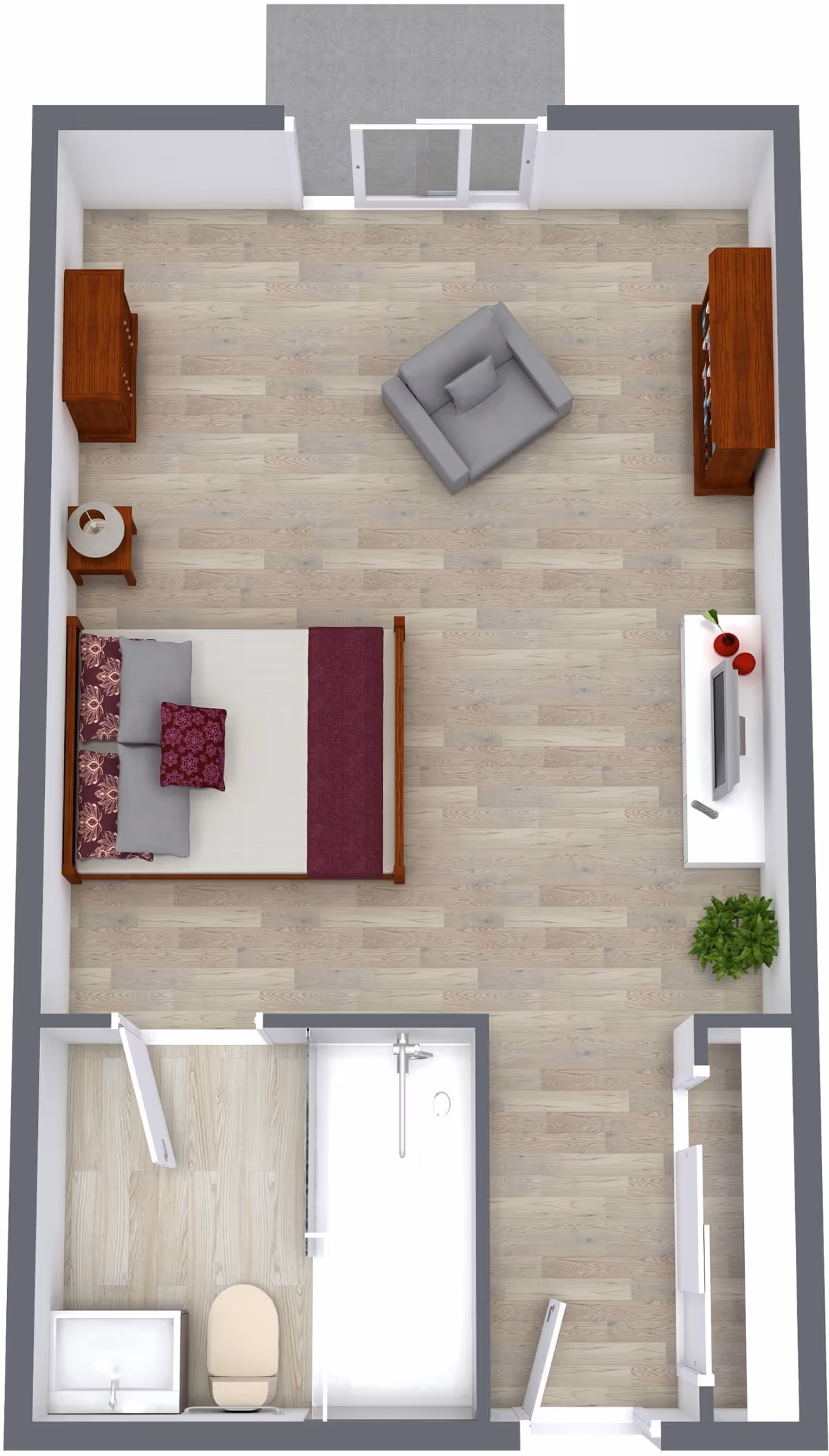 Top-down view of a senior living studio apartment floor plan featuring a bedroom area with a bed, nightstand with lamp, armchair, two wooden cabinets, a TV on a white stand with decorative items, a potted plant, and an attached bathroom with a sink, toilet, and shower.