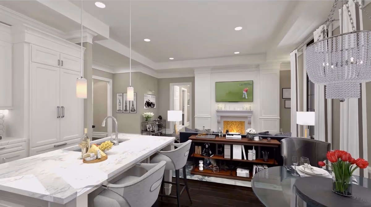 Open-concept kitchen and living area with a marble island and bar stools, a seating area with a fireplace and TV, and a small dining table with flowers.