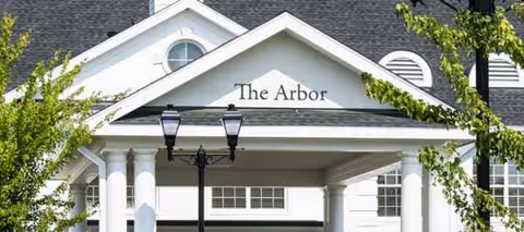 Front exterior of The Arbor at Galloway Ridge with columns and trees