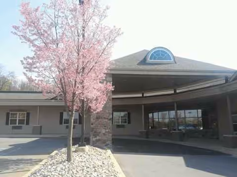 Front view of Abington Manor at Morgan Hill entrance with a pink flowering tree