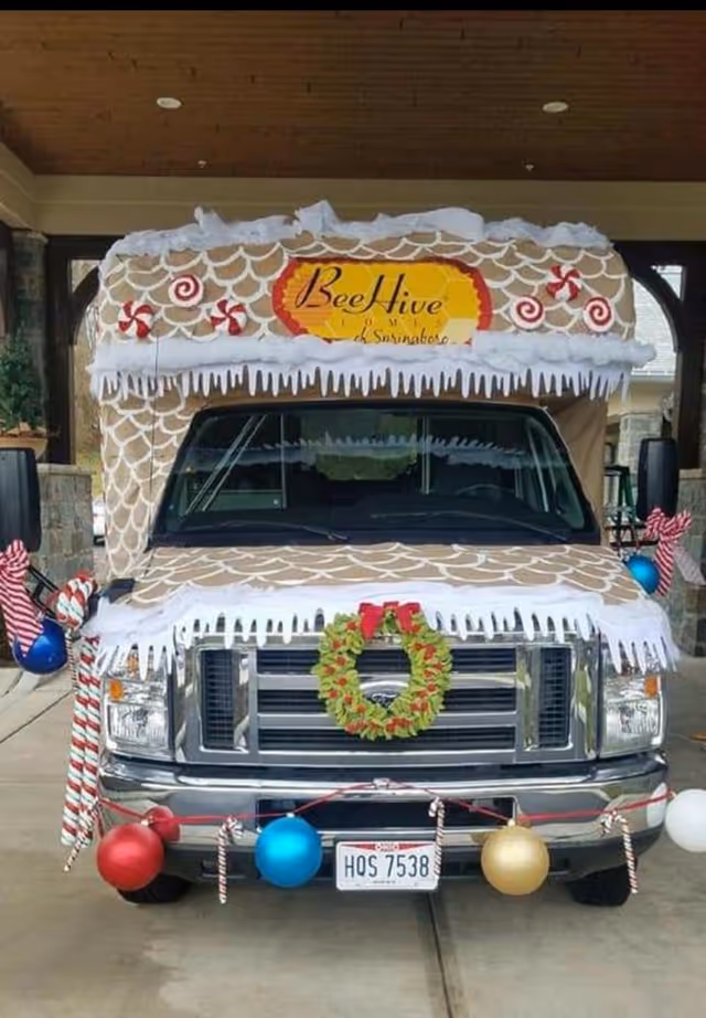 Decorated delivery van resembling a gingerbread house for BeeHive Homes of Springboro.