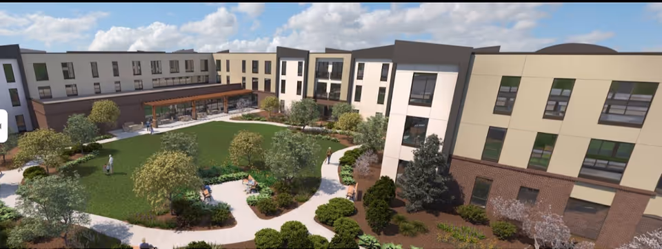 A multi-building senior living campus with a central landscaped courtyard and walkways.