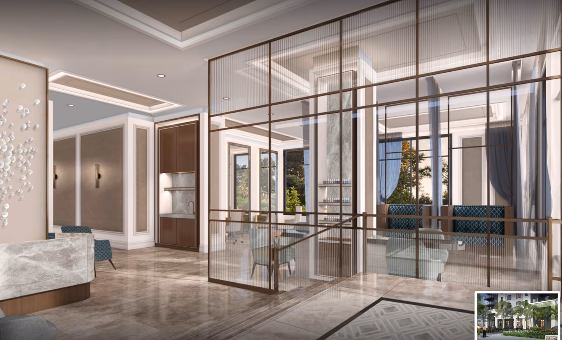A modern and elegant interior space with marble flooring, a reception desk with a marble front, and a glass partition separating a seating area with blue patterned chairs and tables. The room features large windows with blue curtains, recessed ceiling lights, and a small kitchenette area with wooden cabinets and a sink.