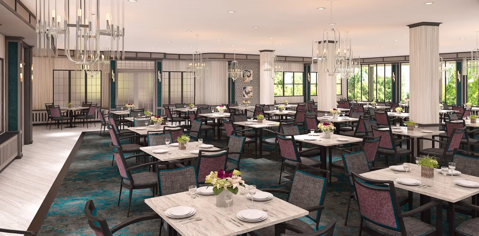 Spacious dining room with multiple tables set with plates, glasses, and floral centerpieces. The room features large windows letting in natural light, elegant chandeliers hanging from the ceiling, and a patterned carpet with teal and dark tones. Chairs around the tables have a mix of purple and gray upholstery.