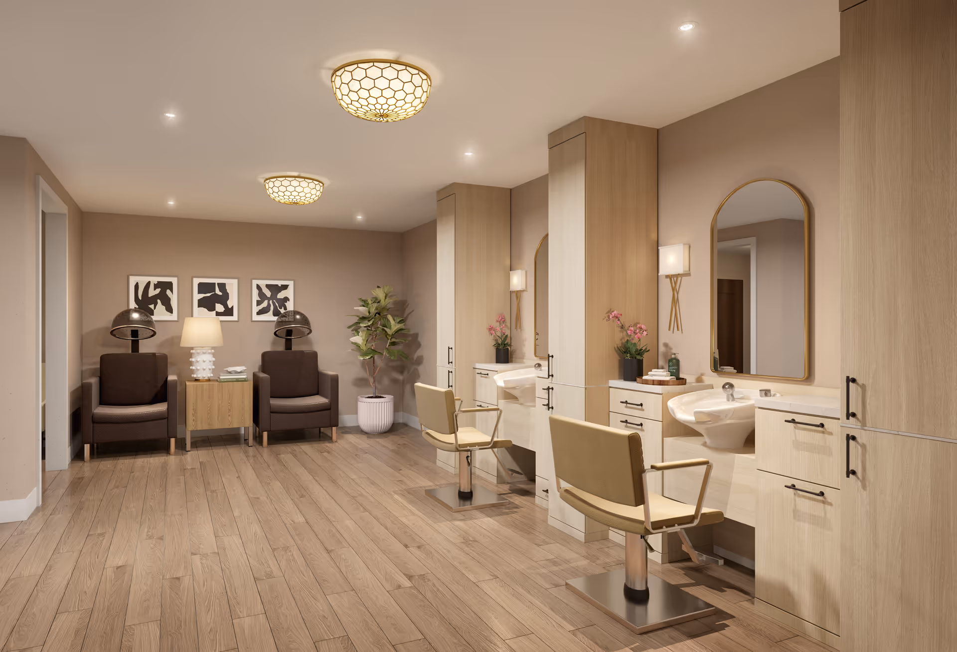 A modern salon area in a senior living facility with two beige salon chairs in front of mirrors and sinks, wooden cabinetry, two brown armchairs with a small table and lamp between them, abstract black and white artwork on the wall, a potted plant, and warm overhead lighting.