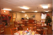 Oil City Nursing and Rehabilitation dining room with tables, chairs, and holiday decorations.