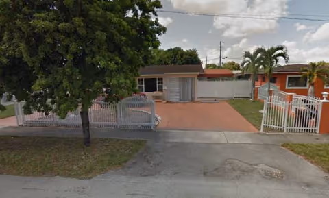 Front exterior of Paradise Adult Center showing a gated entrance and paved driveway.