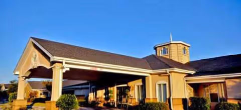 Exterior front view of Brookdale Lake Charles with entrance canopy and blue sky.