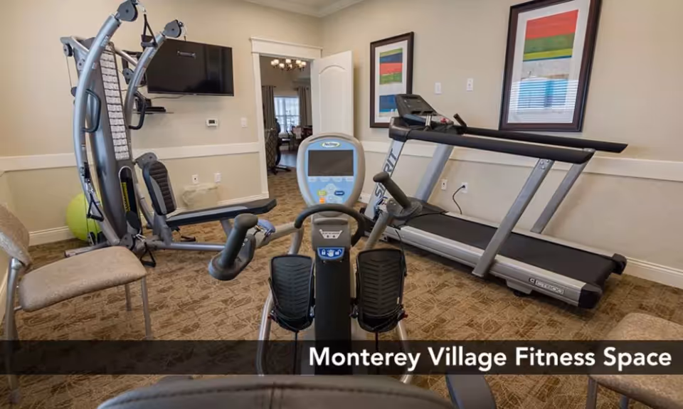 Small fitness room with a treadmill, stationary bike, multi-gym equipment, a wall-mounted TV, and framed artwork.