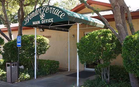 Exterior view of Bender Terrace Main Office entrance with shrubs and trees