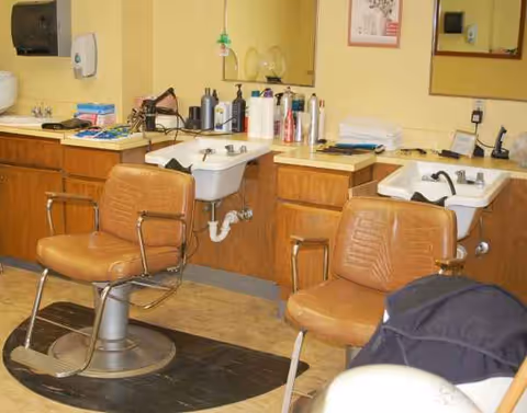 Georgian Gardens Care Center hair salon with two chairs, sinks, mirrors, and grooming supplies.