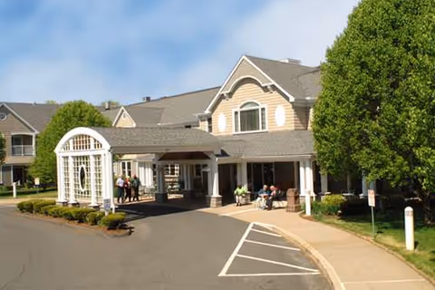 Senior living facility front entrance with porte-cochere and visitors