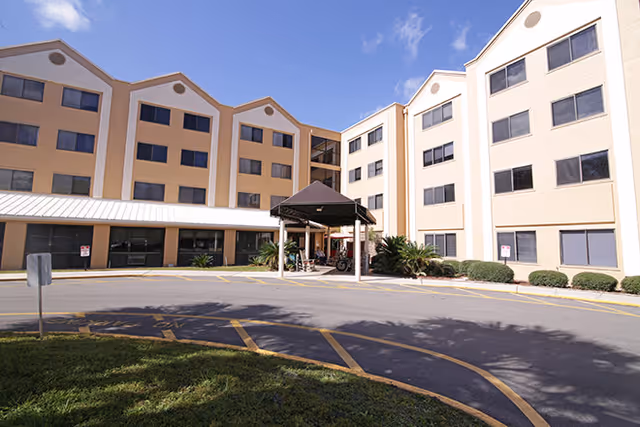 Exterior view of Brookdale Mandarin senior living facility with entrance canopy and parking lot.