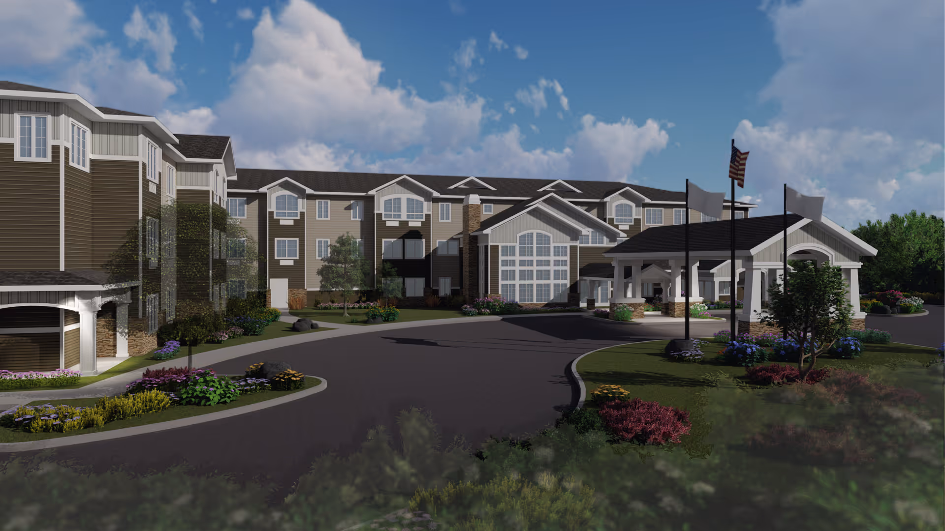 Front exterior of a multi-story senior living facility with a circular driveway, landscaped lawns, and a covered entrance with flags.