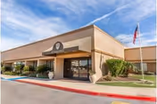 Ridgecrest Post Acute facility front exterior with entrance, flagpole, and manicured landscaping.