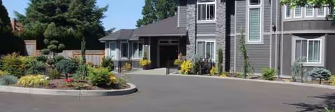 Front view of Campan Senior Care Home with landscaped entrance and driveway in a modern building.
