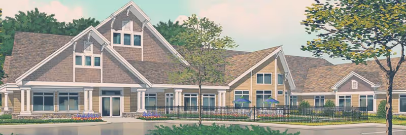 Illustration of a single-story residential building with multiple peaked roofs, large windows, and a front entrance. The building is surrounded by trees, a fence, and landscaping with flowers and shrubs.