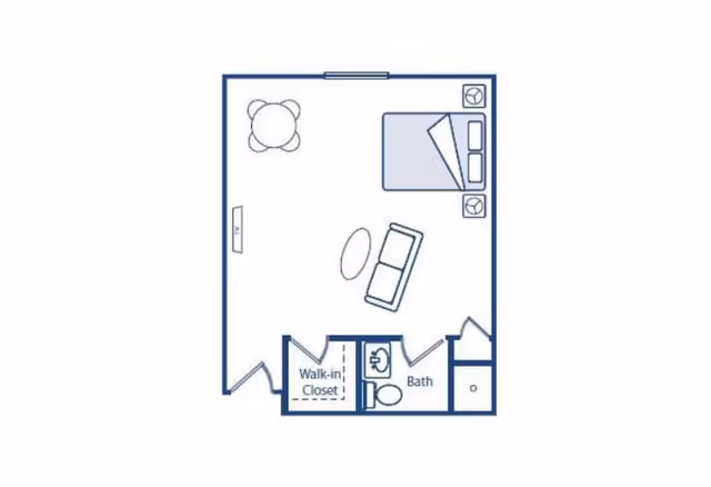 Floor plan of a studio apartment featuring a bed, a sofa with a coffee table, a round dining table with four chairs, a walk-in closet, and a bathroom with a sink and toilet.