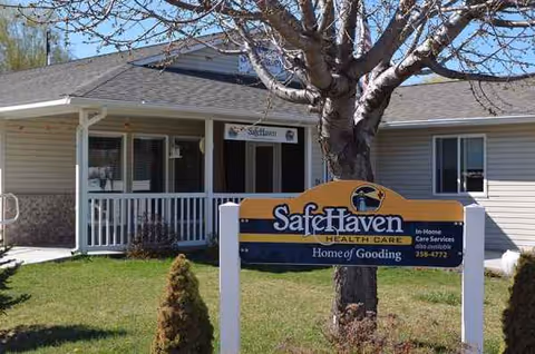 Front view of Safe Haven Health Care facility with entrance, porch, and signage.