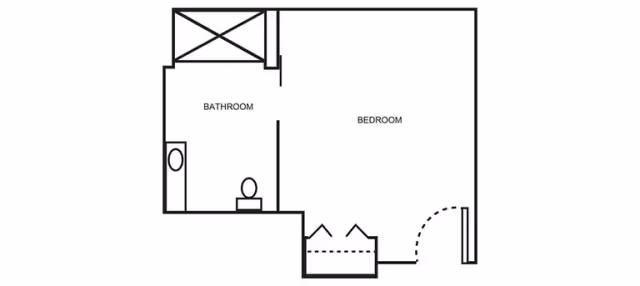 Black-and-white floor plan showing a bedroom, an adjacent bathroom with toilet and sink, and a closet/entry area.
