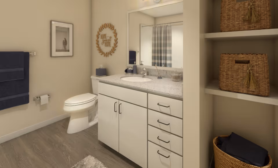 A clean bathroom with a vanity and sink, mirror, toilet, towel rack, and open shelving with wicker baskets.