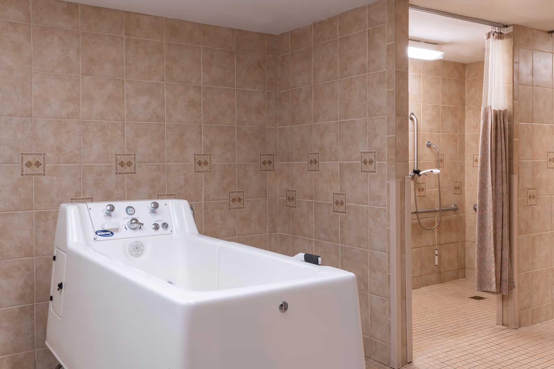 Accessible bathing area featuring a white walk-in tub with controls and a tiled shower with grab bars and curtain.