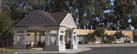 Front view of Medilodge of Lansing with a porte-cochère and single-story building.