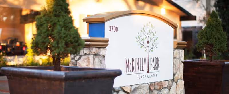 Exterior view of McKinley Park Care Center entrance sign with planters