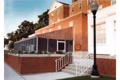 Exterior view of Madonna Manor Skilled Nursing and Rehabilitative Care building with brick facade and stairs.