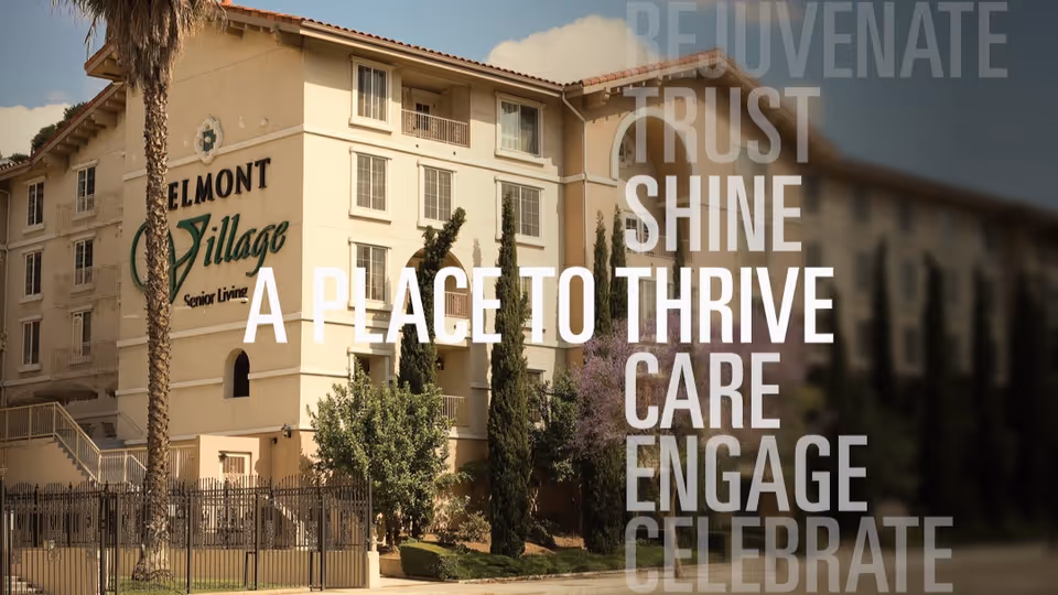 Exterior front of a multi-story Mediterranean-style senior living building with signage and large overlaid promotional text.