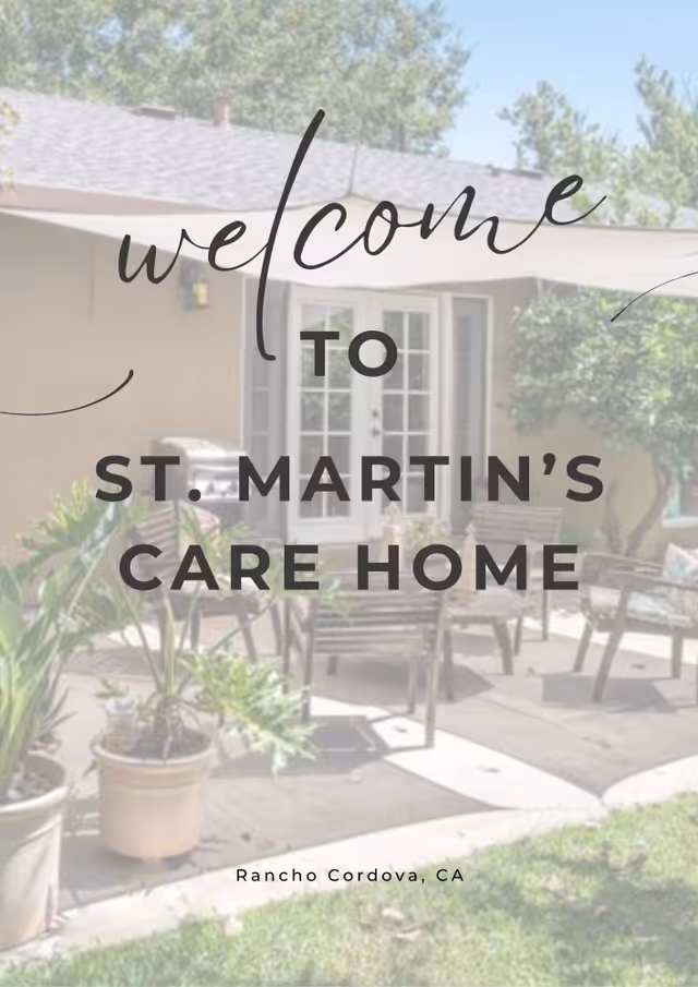 Outdoor patio area of St. Martin's Care Home with wooden chairs, potted plants, and a building with French doors in the background under a clear sky.