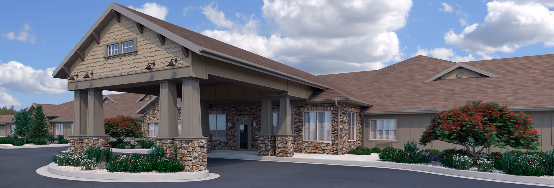 Front entrance of a single-story memory care community with a covered porte-cochère, stone accents and landscaped driveway under a blue sky.