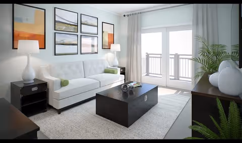 Bright modern living room with a white sofa, dark coffee table, framed wall art, and glass doors opening to a balcony.