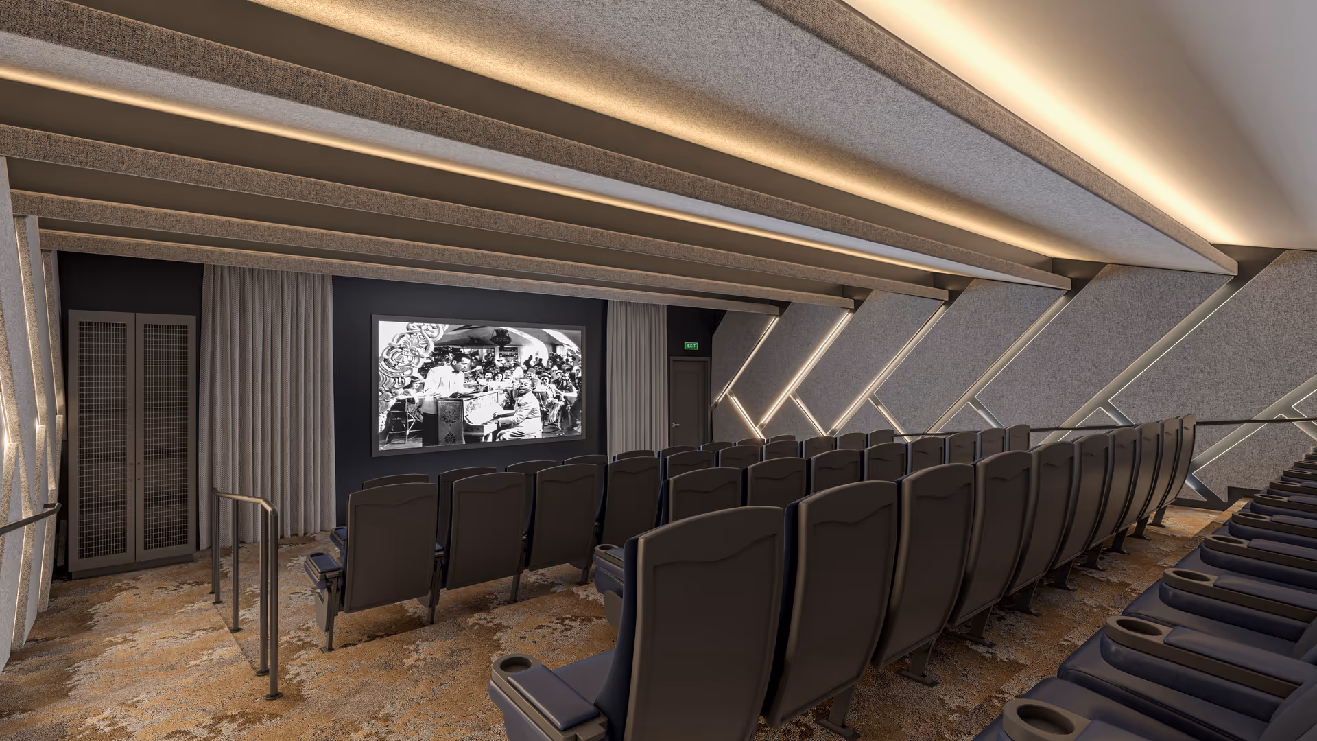 A modern theater room with multiple rows of black cushioned seats facing a large screen displaying a black and white image. The room features angled walls with integrated lighting and a carpeted floor with a patterned design.