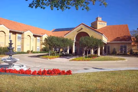 Front exterior view of Park Place Nursing and Rehabilitation Center with fountain and landscaping.