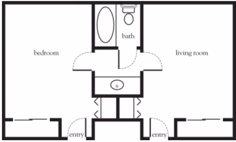 Floor plan layout showing a bedroom on the left, a living room on the right, and a centrally located bathroom with a bathtub, toilet, and sink. There are two entry points at the bottom leading into the bedroom and living room respectively.